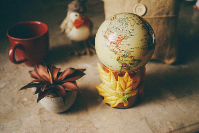 We use this pumpkin candle as a base and tie twine around some leaves to enhance the aesthetic.